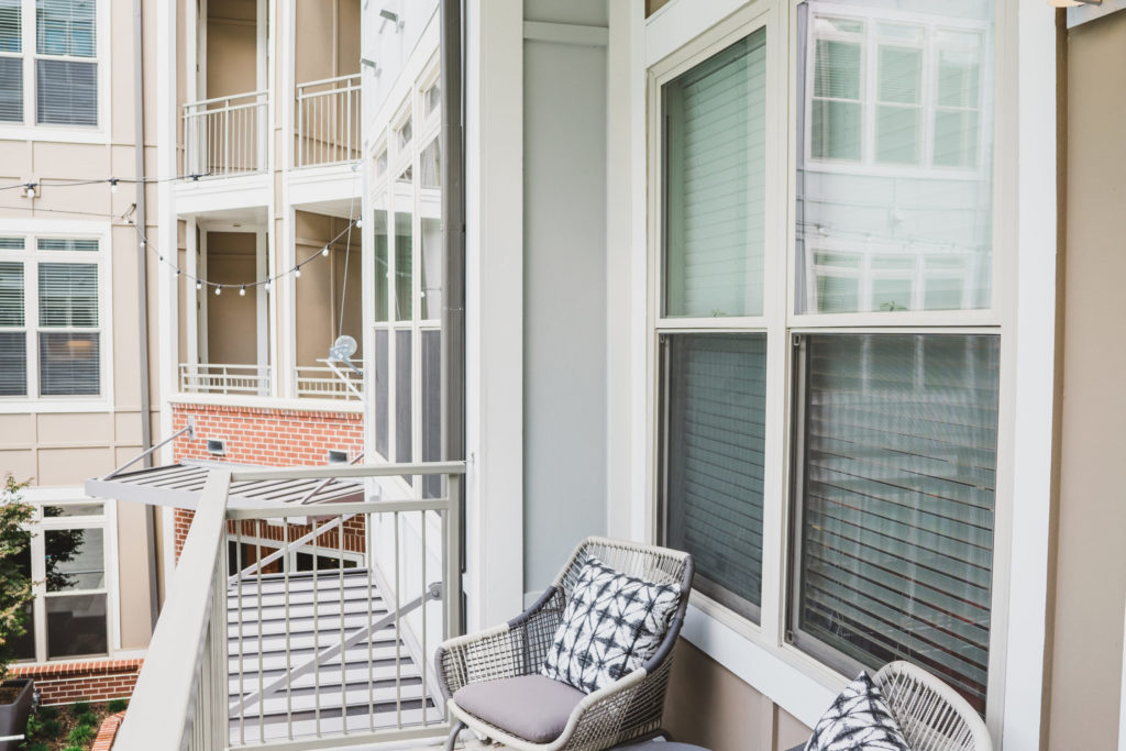 Apartment balcony with two designer chairs