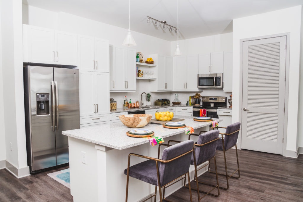 gourmet kitchen featuring stainless steel appliances and pendant lighting - Work and Play in Atlanta